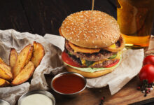 fast food burger and potatoes served with beer at restaurant