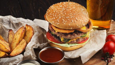 fast food burger and potatoes served with beer at restaurant